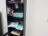 a black bookcase filled with books in a room