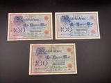 three old german bank notes on a black background