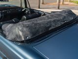a blue car with a black bag on the top of it