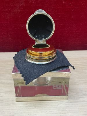 a small silver box with a black cloth on it