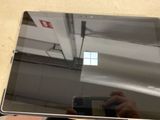 a person taking a picture of a laptop with a cell phone