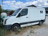 a white van that is parked in the dirt
