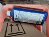 a bottle of liquid sitting on top of a cardboard box