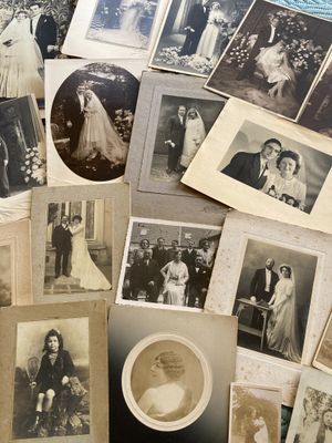 an old photo of a bunch of photos of people on a table