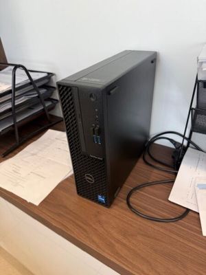 a desktop computer sitting on a desk next to a printer