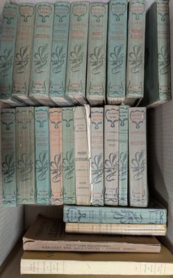 many books stacked on top of each other on a shelf