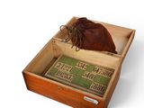 a wooden box with a leather bag inside of it