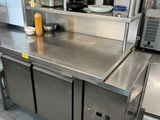 a large stainless steel counter in a commercial kitchen