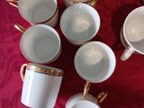 a lot of coffee cups arranged in a circle on a table