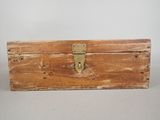 an old wooden box sitting on a table with a lock on it