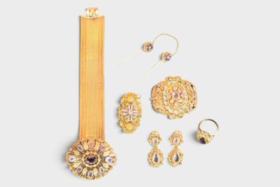 an image of a collection of gold jewelry on a white background