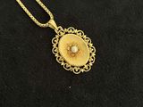 a close up of a necklace on a black surface