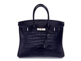 an image of a black crocodile skin handbag on a white background