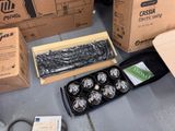 several boxes of assorted items sitting on the ground next to each other