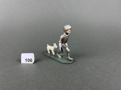 a miniature figurine of a man on a surfboard with a dog