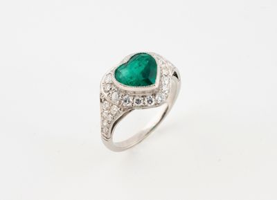 a heart shaped emerald and diamond ring