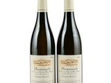 two bottles of wine sitting next to each other on a white surface