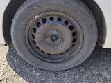 a white car that has a flat tire on it