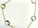 an image of a bracelet with multi colored stones on it
