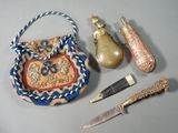 un sac à main muni d'une anse, un couteau et d'autres objets posés sur une table