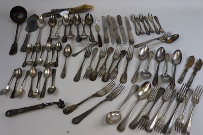 many spoons and forks laid out on the table