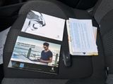 a picture of a car seat with a magazine and a mouse on it