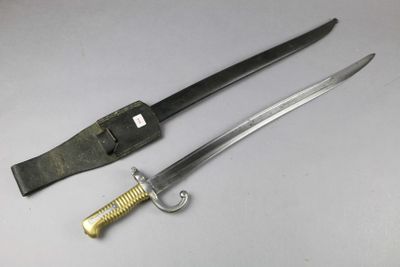 a knife that is laying next to a knife on a table