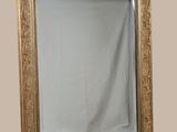 a mirror that is sitting on the floor in front of a wall