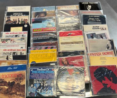 a lot of music cds and cds on the table