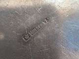 a close up of a silver plate with a name engraved on it