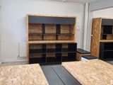 a room that has plywood floors and shelves in it
