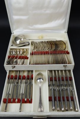 a box with silverware in it on a black surface