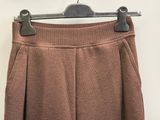 a close up of a brown skirt hanging on a hanger
