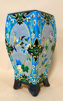 a blue vase with birds and flowers on it
