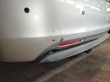 the rear end of a white car with a denting bumper
