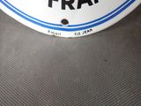 a close up of a white and blue sign on a table