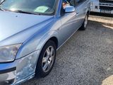a picture of a silver car parked in a lot