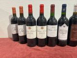 several bottles of wine are lined up on a table
