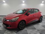 a red car is parked in a room with a checkered floor