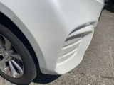 a close up of a white car ' s front tire