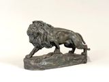 statue of a lion on a rock on a white background