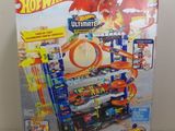 a box of hot wheels ultimate track set with a toy car