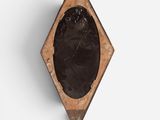 a close up of a wooden plaque on a white wall