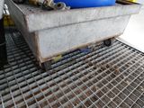 a metal crate with a blue container on it