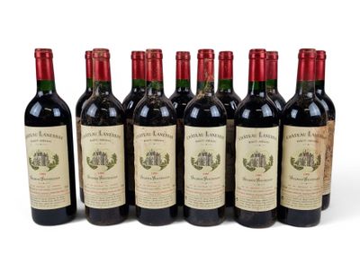 six bottles of wine lined up in a row on a white surface