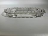 an antique glass tray with a decorative design on it