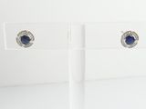 pair of sapphire and diamond stud earrings on clear acrylic stand
