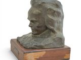 sculpture of a woman ' s head on a wooden base