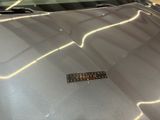 a close up of the hood of a car with a sticker on it