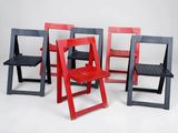 several chairs are arranged in a row on a white surface